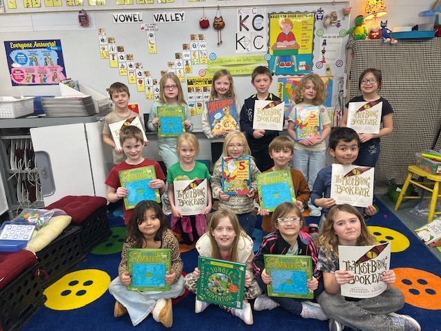 Students posing with books.