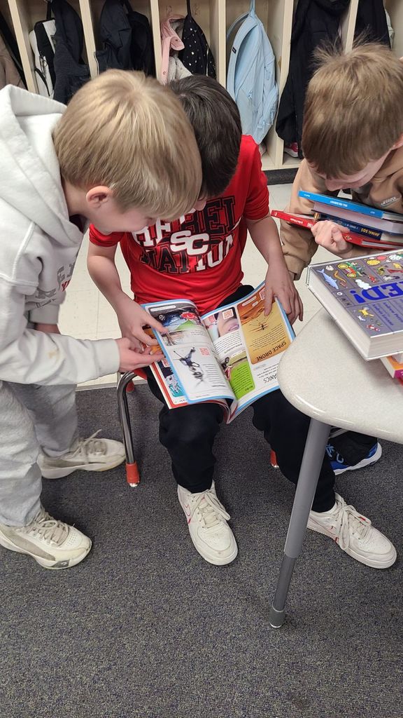 Students posing with books.