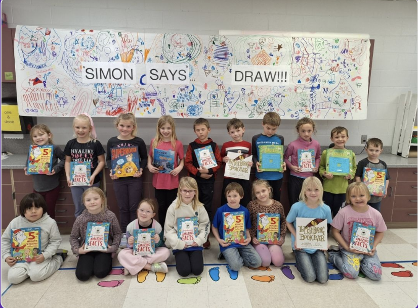 Students posing with books.