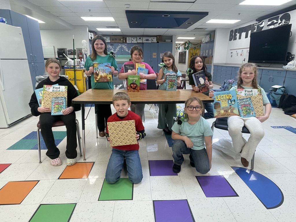 Students posing with books.