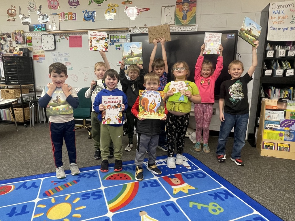 Students posing with books.