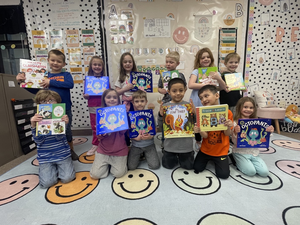 Students posing with books.