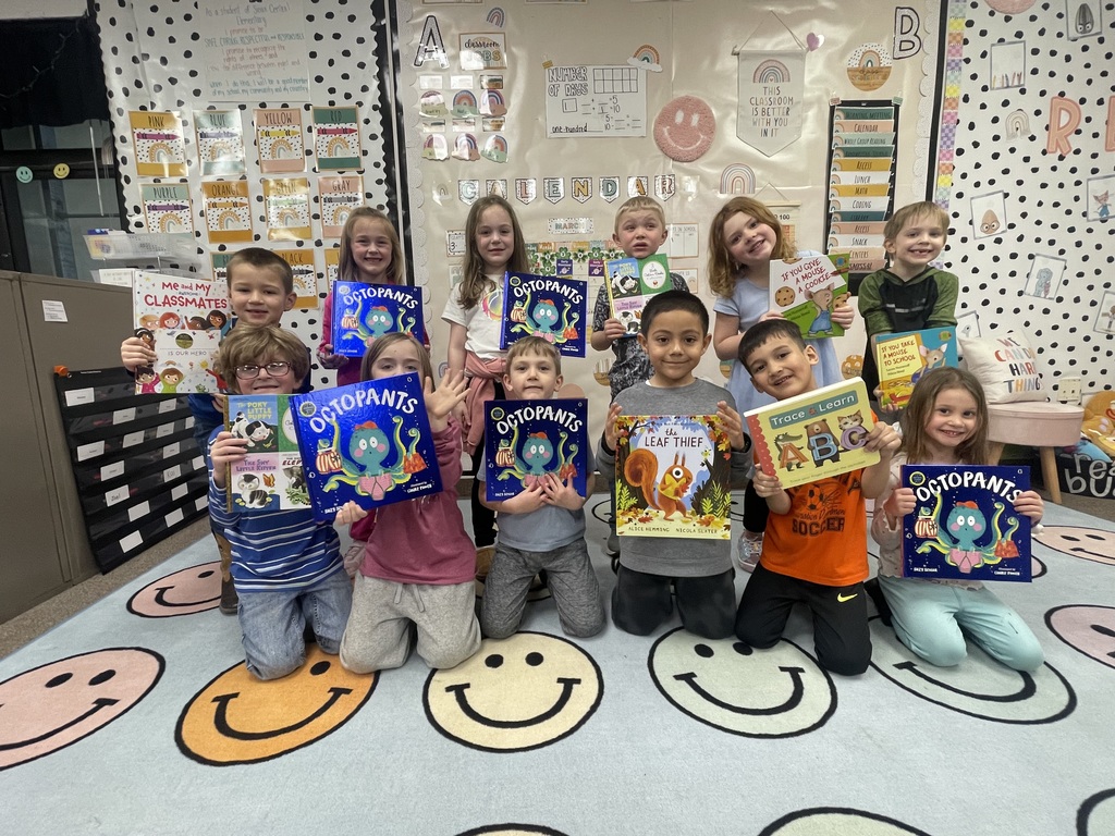 Students posing with books.