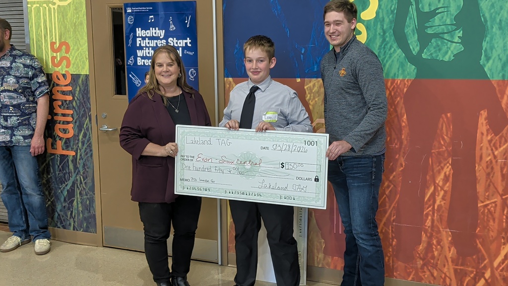 kids posing with a check (TAG)