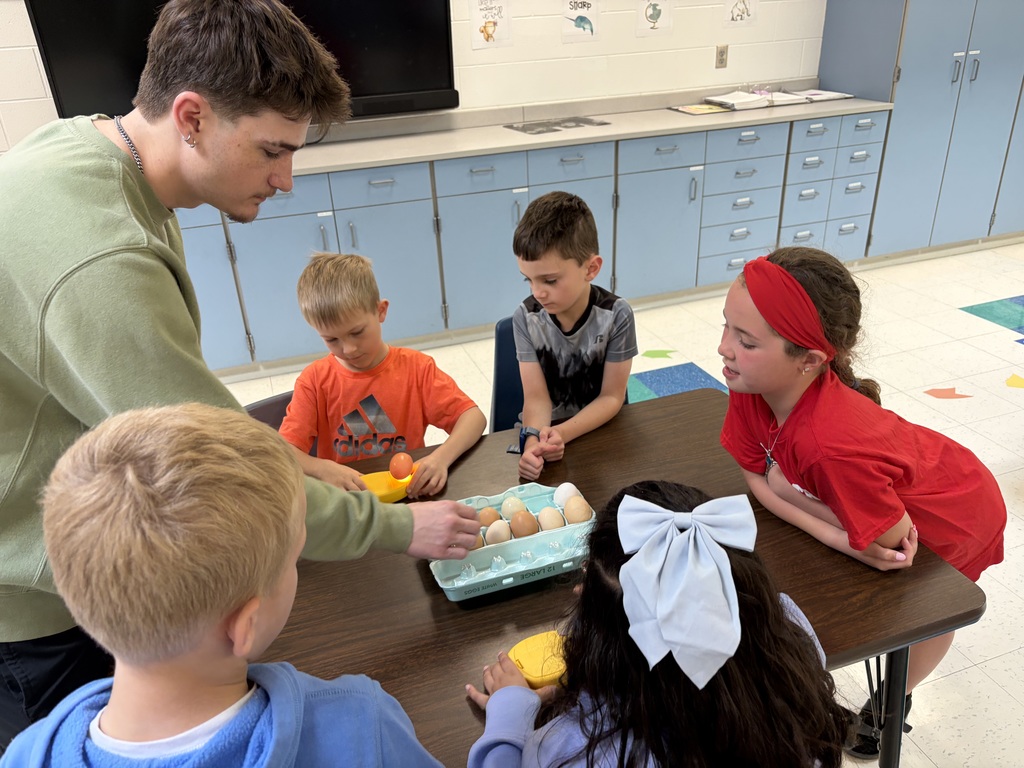 high school students working with elementary students