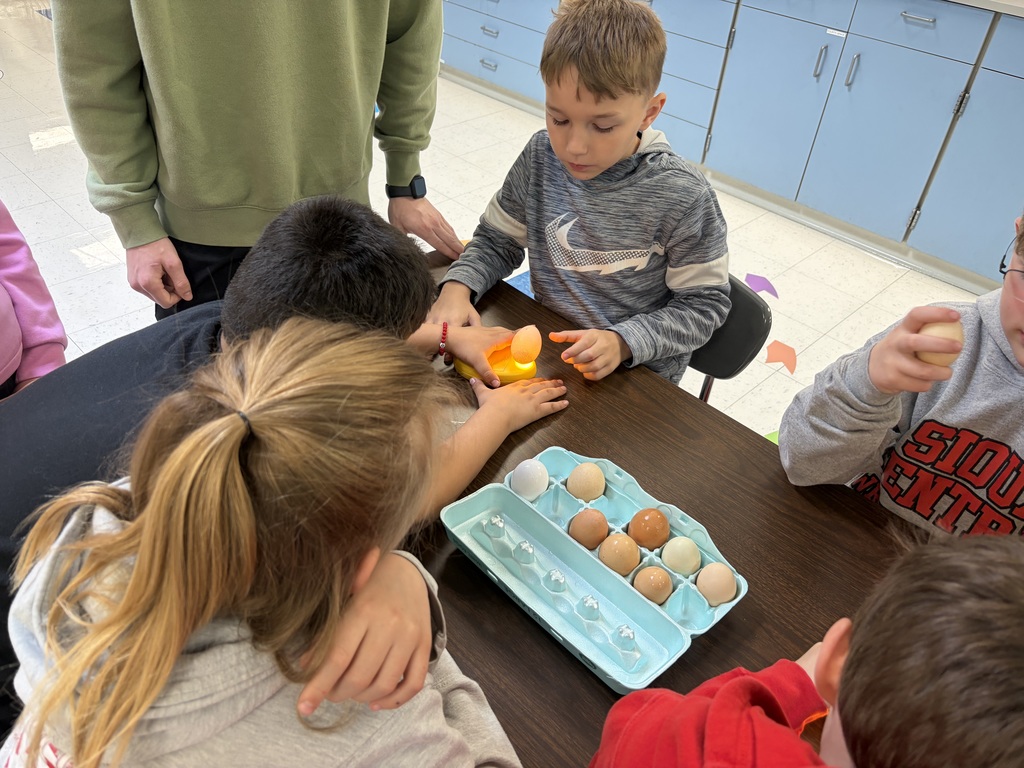 high school students working with elementary students
