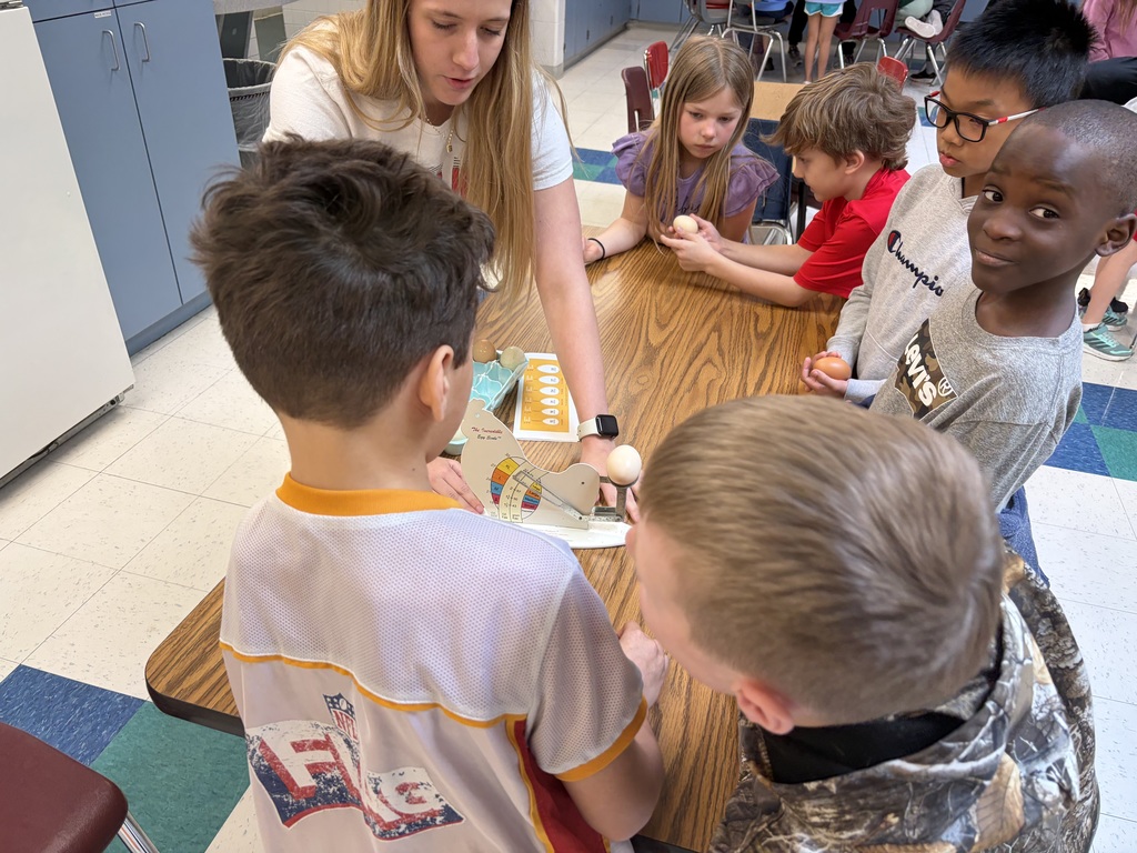 high school students working with elementary students