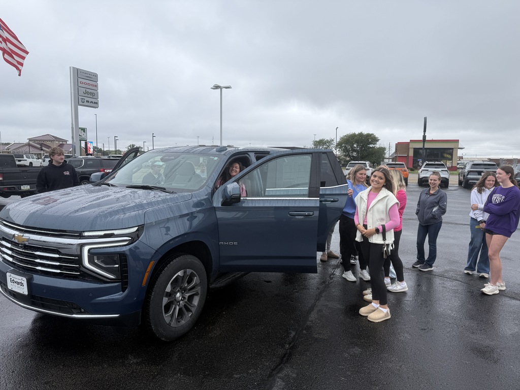 students standing in front of car