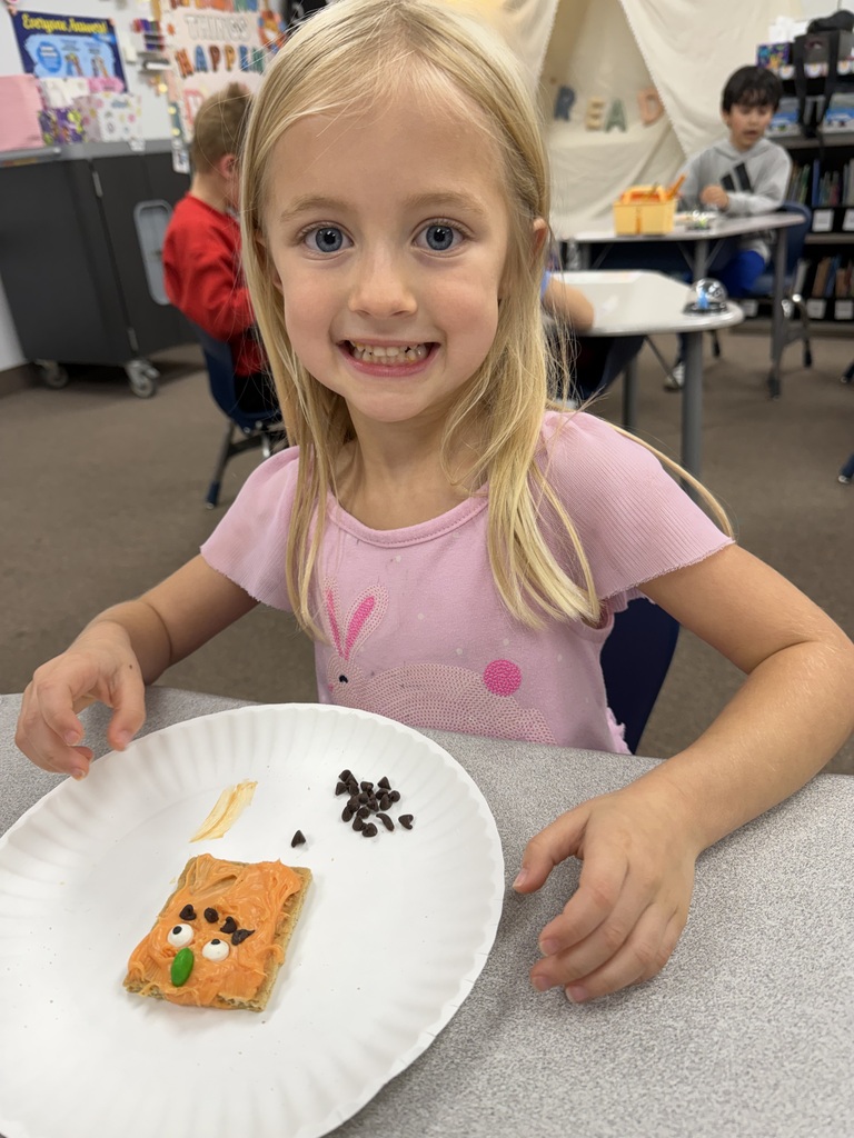 kid posing with pumpkin snack