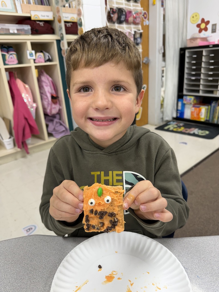 kid posing with pumpkin snack