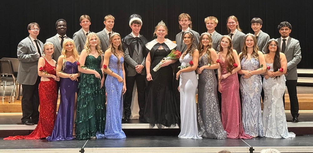 East High Homecoming Royalty poses on stage.