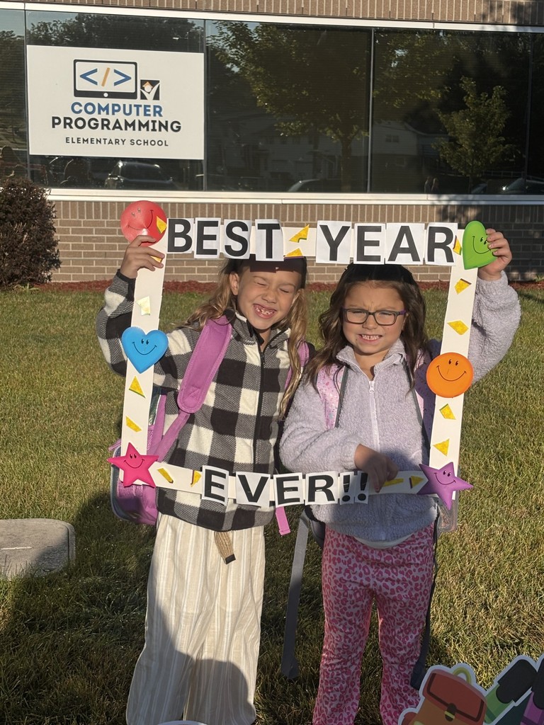 2 students holding a sign that says "best year ever!!"