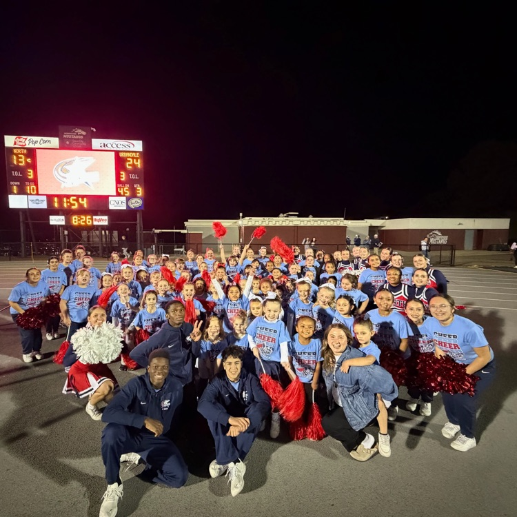 youth cheerleaders with the high school cheerleaders