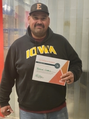 Brandon Gomez holds staff member of the month certificate