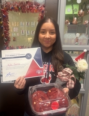 Aylin Garcia poses with a certificate and food