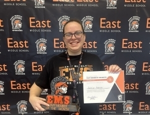 Katelyn Andersen poses with a plaque and her certificate