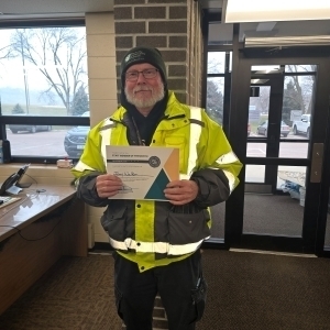Jerry Walker, poses with a certificate