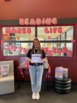 Kaitlin Ballard holding a certificate