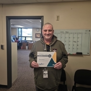 John Levasseur poses with a certificate