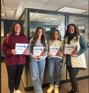 Erica Bonderson, Erica Van Horssen, Megan Casey, and Angie Miller pose together with certificates