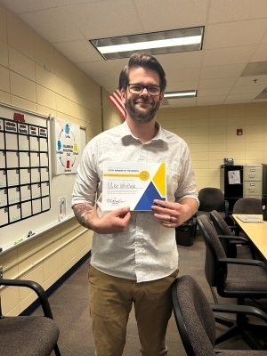 Mike Whitlock poses with a certificate