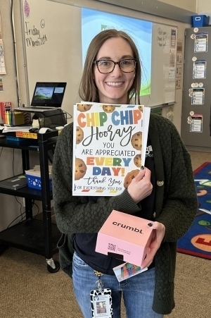 Amber Minton poses with a certificate and cookies