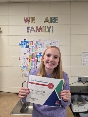 Kaitlyn Reynolds poses with a certificate