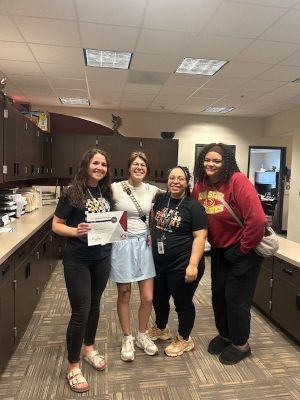 Carson Clayborne and the Compass Academy team (Miss Abby, Miss Jasmine, and Miss Kyleigh) pose as a team
