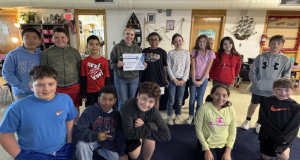 Whitney Hellman poses with her class and a certificate