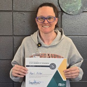 April Fuller poses with a certificate