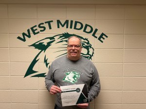 Frank Peck poses with a certificate