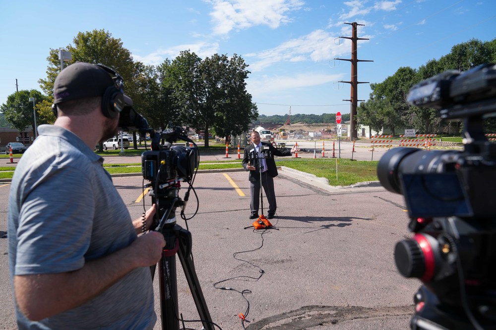 Superintendent Dr. Jamie Nold talks to reports about construction at Lincoln High School with the construction zone behind him
