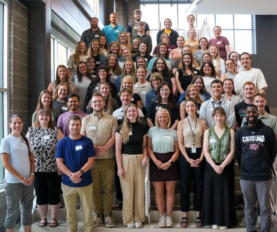 Group of young teachers stand on a staircase at Jefferson High School