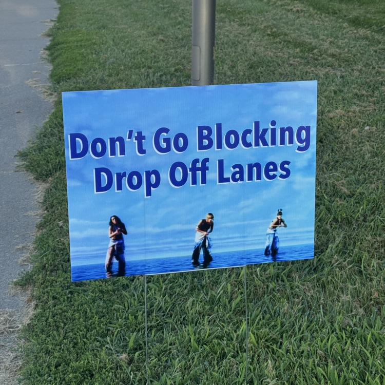 A yard sign with the band TLC saying don’t go blocking drop off lanes