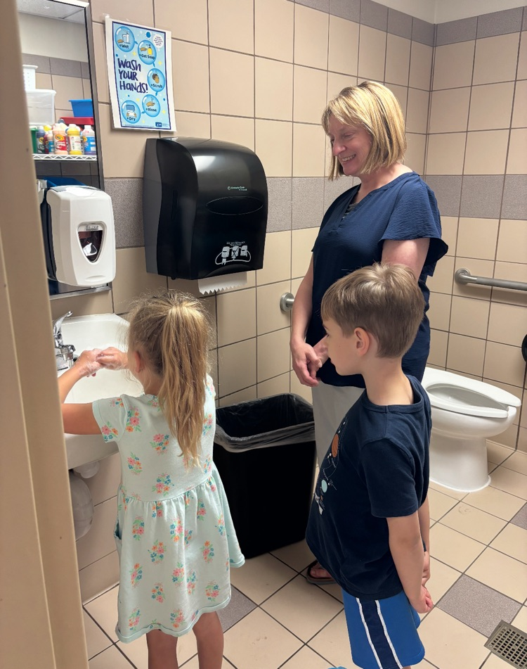 nurse Kari helping kindergartners learn to wash hands