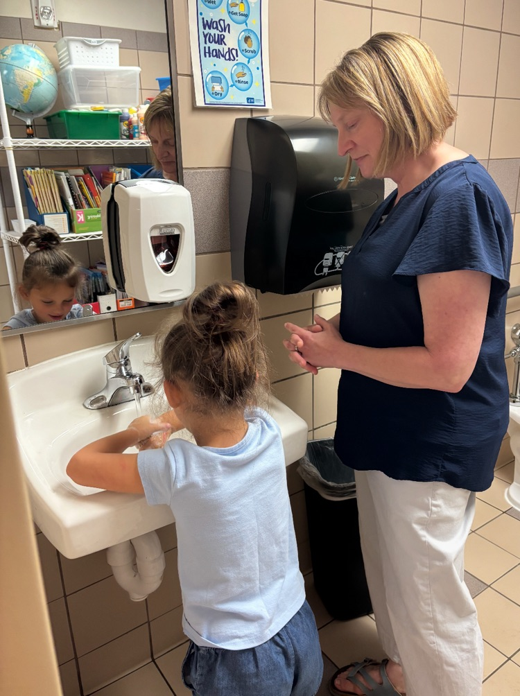 nurse Kari helping kindergartners learn to wash hands