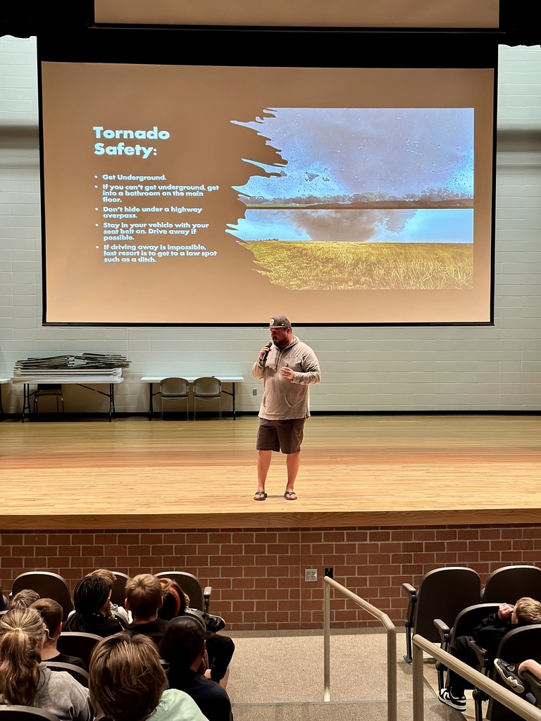 A close-up of Chris Chittick speaking enthusiastically to Memorial sixth graders about storm safety and chasing tornadoes.