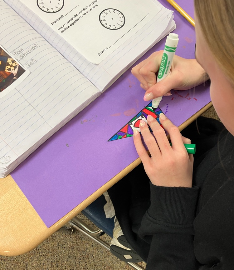 student working on a math and art piece