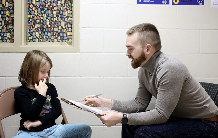 a child and a man participating in the smart bowl 