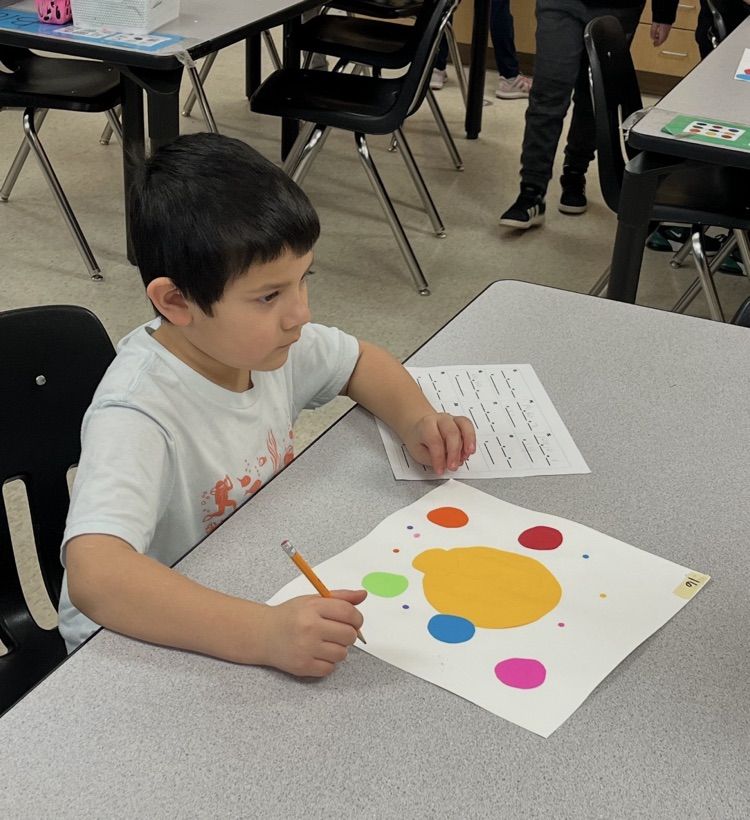 a 2nd graders working on an art piece.