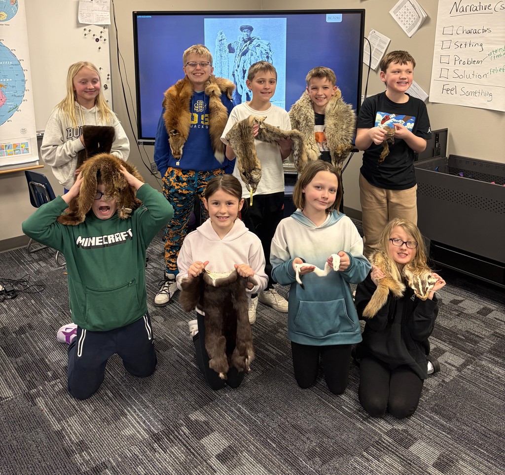 Students holding animal furs. 