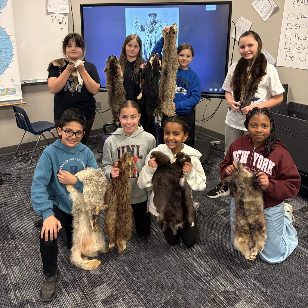 Students holding animal furs. 