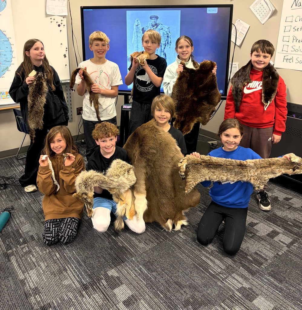 Students holding animal furs. 
