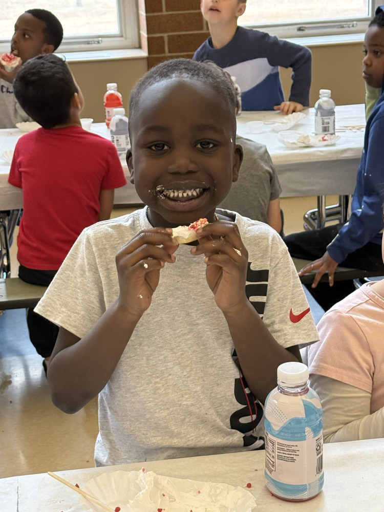 enjoying his frosted cookie