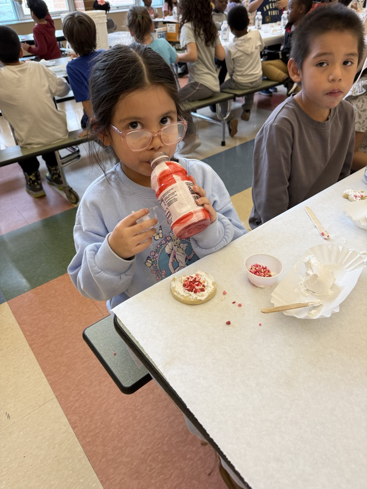 enjoying her frosted cookie