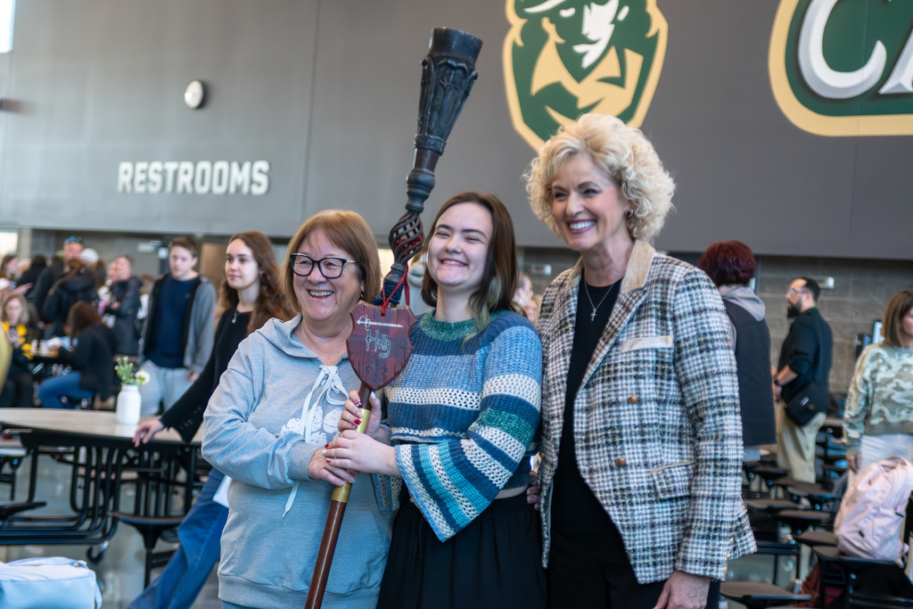 Student posing for picture with Survivor 21 contestant Holly Hoffman