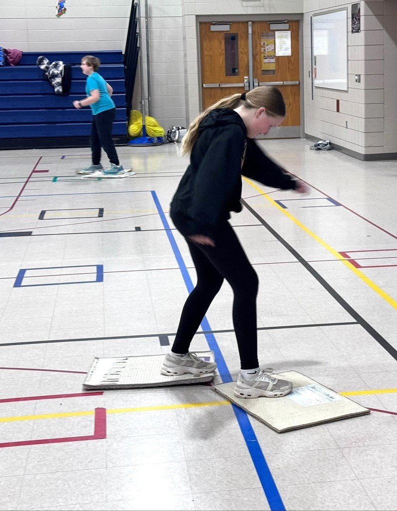 Students speed skating in PE class. 