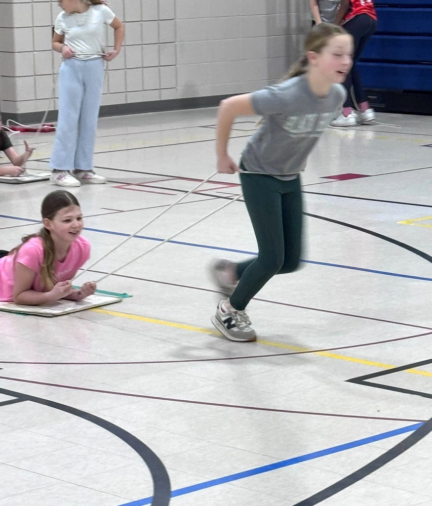 Students luge racing in PE class. 
