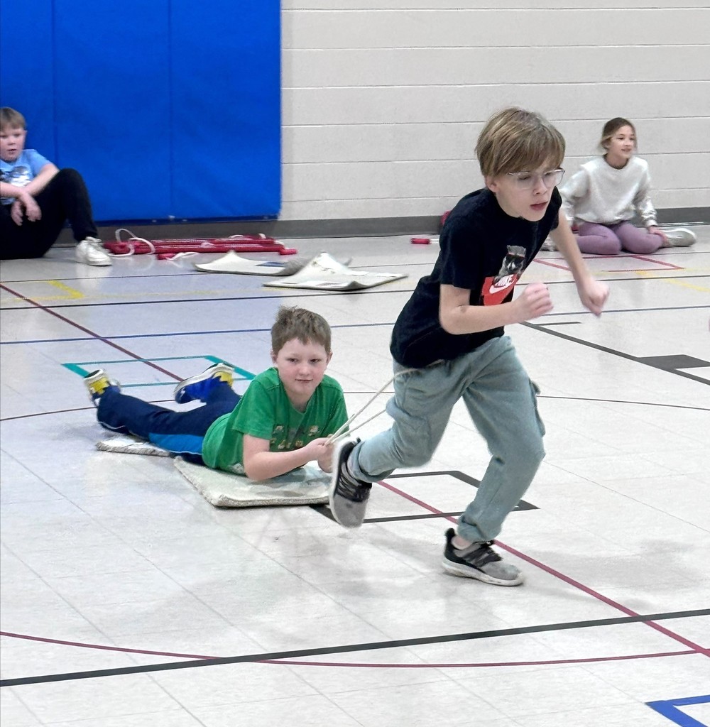 Students luge racing in PE class. 