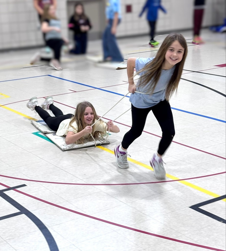 Students luge racing in PE class. 
